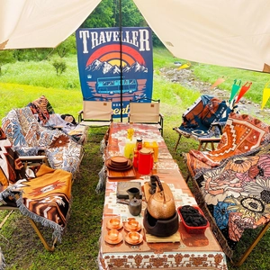 Ethnic bohemian style outdoor camping blanket with fringe edges for picnic decor