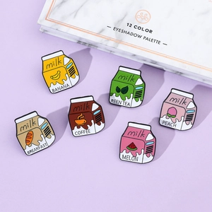 Flat lay of six colorful milk carton enamel pins on a lavender background