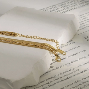 Detail of gold double-layer snake and link necklace with S925 engraved clasp