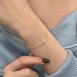 Elegant S925 sterling silver gold bracelet with dual zircon crystals on a wavy chain