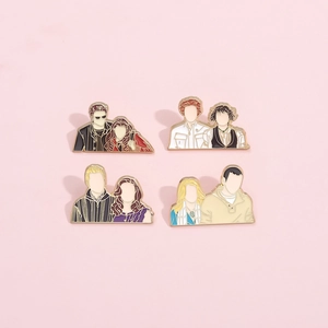 Detailed flat lay of minimalist enamel Twilight character pins on pink background