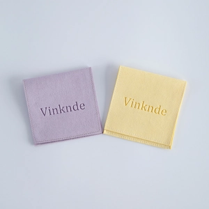 Premium velvet jewelry pouches in purple and beige with minimalist flap design