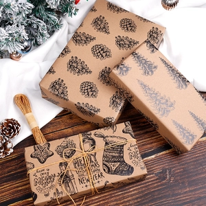 Brown kraft Christmas wrapping paper featuring pine cones, trees and Merry Christmas prints