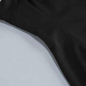 Macro shot of curved stitching and smooth black matte fabric texture on the strapless dress