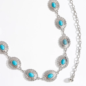 Close-up of silver metal waist chain featuring oval blue turquoise stones and adjustable links