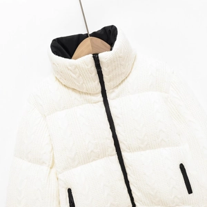 Women's white cable knit puffer jacket with black stand collar and zip closure