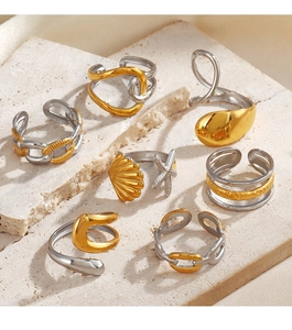 Detail shot of a 7-piece two-tone mixed ring set with shell and chain designs on stone