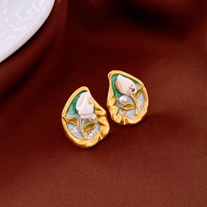 Detail of vintage enamel earrings with gold plating, seashell motif and small pearls