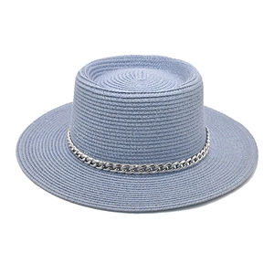 Detail of light purple woven boater hat featuring a stylish silver metal chain band