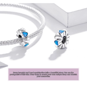 Macro shot of S925 sterling silver snake chain bracelet with blue opal heart charms