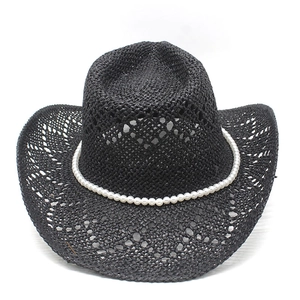 Detail of black woven cowboy hat featuring faux pearl band and breathable texture