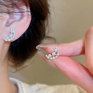 Detailed close-up showing the moon-shaped stud earring with pearls and cubic zirconia