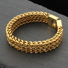 Macro view of gold-plated braided steel mesh texture and secure square clasp closure