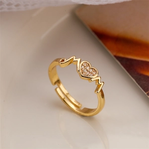 Macro detail of gold adjustable ring featuring heart-shaped zircon and pulse heartbeat lines