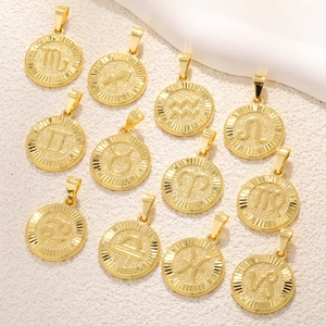 Golden zodiac coin pendants set with embossed astrological signs on textured surface
