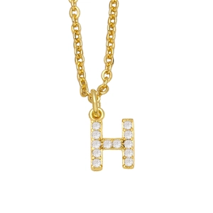 Detailed macro view of a gold-plated letter H pendant necklace with sparkling zircons