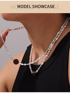 Detail of silver square beads necklace with tiger eye stone pendant on model neck
