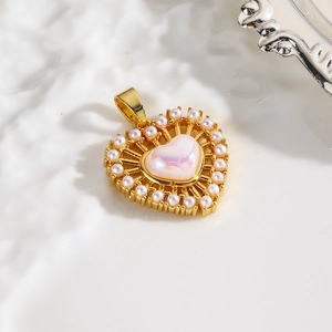 Detailed close-up of golden heart pendant with pink gemstone and pearl border inlay