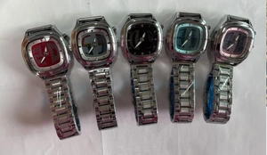 Detail view of five vintage alloy quartz watches with colorful globe pattern dials.