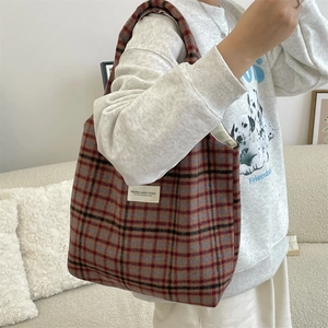 Detail shot of vintage plaid woolen tote bag showing texture and fabric pattern