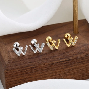 Detail of 925 sterling silver W-shaped screw back earrings in gold and silver finish