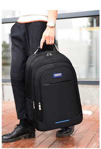 Detailed view of the durable black nylon business backpack with metal logo and zipper pocket