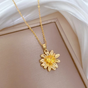 Detailed close-up of a luxury champagne gold sunflower necklace with a yellow gemstone
