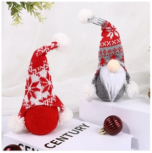 Detail of Christmas gnomes with knitted snowflake patterns on soft fabric stands