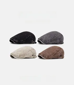Detail view of four vintage washed newsboy caps in black, grey, beige, and coffee brown