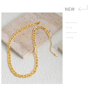 Macro shot of 18k gold plated stainless steel anchor link necklace with lobster clasp