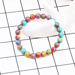 Detailed close-up of 8mm tiger eye agate beaded bracelet with multicolor vortex patterns