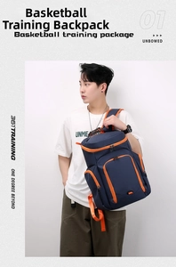 Dark blue basketball backpack with orange zippers worn by a male model against white background