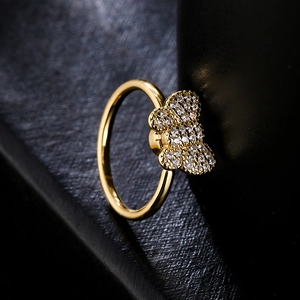 Rotating floral gold ring with sparkling cubic zirconia on a minimalist sleek band