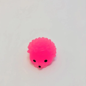 Close-up of a pink glowing hedgehog stress toy with soft TPR texture and spiked surface