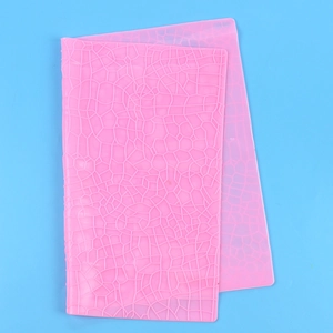 Detailed view of pink silicone mat featuring realistic tree bark texture for cake baking