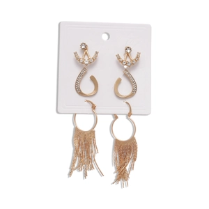 Six-piece set of geometric gold earrings with diamonds and tassels on a white card