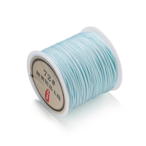 Close-up of light blue 0.8mm polyester jade cord roll for DIY jewelry weaving