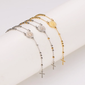 Three stainless steel rosary bead necklaces in gold and silver with cross and medal charms
