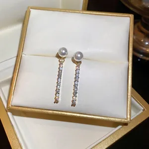 Gold plated pearl drop earrings with sparkling micro-pave zirconia in a jewelry box