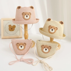 Detail of straw hat and crossbody bag set with cute bear patch for kids summer