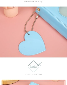 Detail of light blue heart-shaped acrylic pendant on a silver ball chain accessory