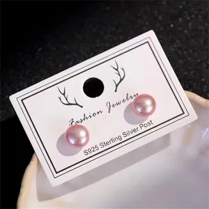 Close-up of pink freshwater pearl earrings with S925 silver needles on jewelry card