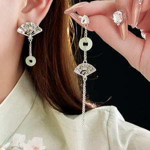Detail of long tassel fan earrings with green jade stone and silver needle fringe