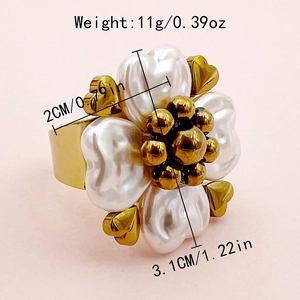 Detail view of gold flower ring with white pearl petals and size measurements info