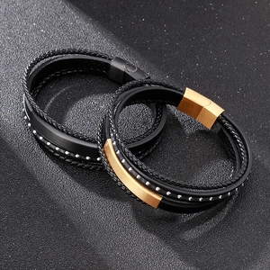 Detail of woven leather bracelets with magnetic stainless steel clasps in black and gold
