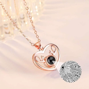 Macro detail of rose gold heart antler necklace with love projection stone element