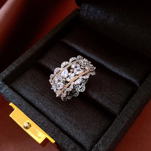 Detailed view of luxury hollow lace ring with zircon inlay and bicolor vintage plating