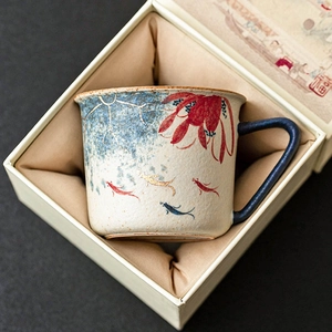 Hand-painted ceramic coffee cup with lotus and koi fish design in silk-lined gift box