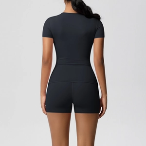 Back view of a black high-waisted tight yoga set featuring slim fit top and sports shorts