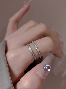 Detail of two silver matte finish stacking rings with a subtle shimmer on model fingers